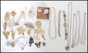 A collection of vintage costume jewellery to include predominantly brooches, bangle, pearl