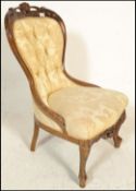 A good 20th Century walnut spoon back library armchair  being raised on walnut turned legs with