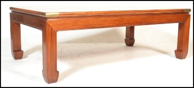 A large 20th Century mahogany rectangular coffee table in the Chinese taste, set with brass mounts