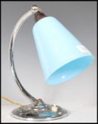 An early 20th Century Art Deco desk / table lamp, having a chrome circular base, chrome bend support