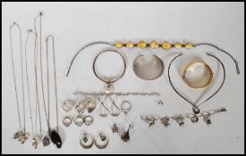 A group of mostly silver jewellery to include two silver bangles one having a mother of pearl