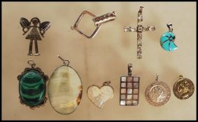 A group of silver pendants to include one in the form of a shell having turquoise enamel