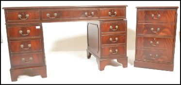 A reproduction Georgian style mahogany veneered kneehole twin pedestal writing desk with tooled