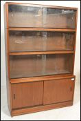 A retro 20th Century four section stacking bookcase unit by Simplex. Three section above having twin