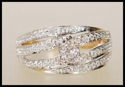 A hallmarked 9ct yellow gold ring having cross ove