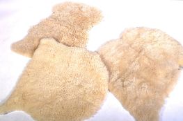 SET OF THREE SHEEPSKIN WOOLLEN FLOOR RUGS