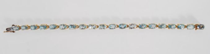 14CT YELLOW GOLD AND AQUA MARINE COLOURED STONE LINE BRACELET