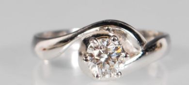 An 18ct white gold single stone diamond cross over