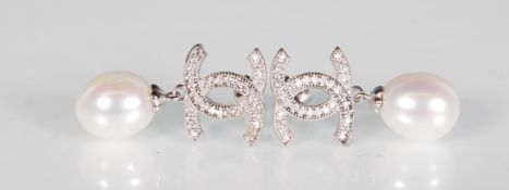 A pair of silver designer style earrings set with