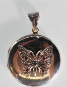 A silver picture locket of round form having appli