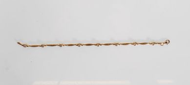 A stamped 375 9ct gold spacer bracelet being set w