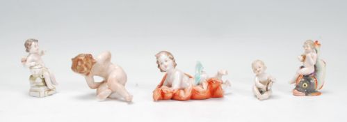 A group of five early 20th Century Capodimonte Naples ceramic figurines in the form of babies /