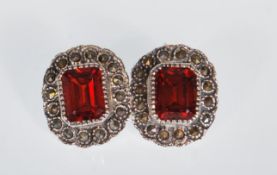 A pair of ladies silver stud earrings set with rec