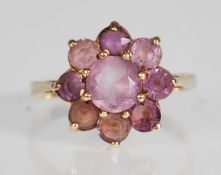 A 9ct yellow gold ring having a flower head mount