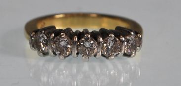 A stamped 18ct white gold five stone ring set with