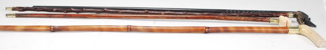 A group of four walking sticks to include a bamboo