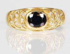 An 18ct gold ring set with an oval cut sapphire wi