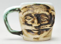 A Devon studio art pottery mug signed Andre Loret