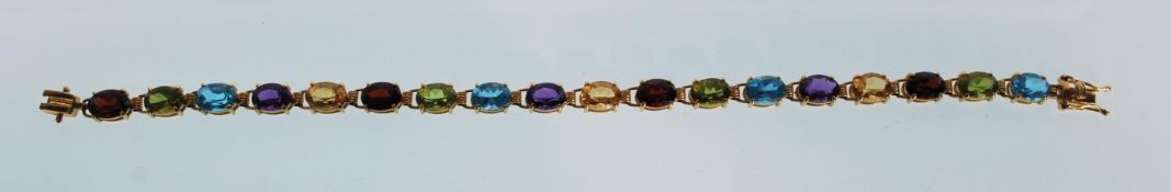 A stamped 14k 14ct gold tennis bracelet set with m