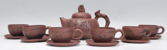 A Chinese Yixing clay teapot having carved decorat