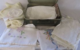 Small suitcase containing assorted linen