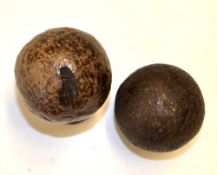 2x smooth guttie percha golf balls – one large well used and another smaller size