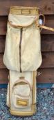 Canvas and leather cream coloured golf bag with the makers triangular logo stamped to the base (