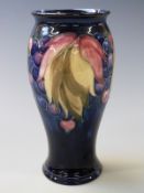 William Moorcroft baluster vase in Leaf and Berry pattern , with impressed 'potter to HM the