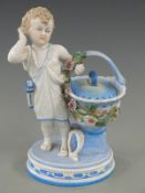 KPM figural sweetmeat dish in the form of a boy holding a lidded basket, 25cm tall