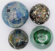 Four signed glass paperweights including one by Allain Guillot, largest 88mm in diameter.