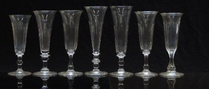 Seven 19thC and later cut glass champagne flutes or ale glasses, some with knopped stems, most