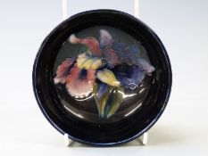 Moorcroft pedestal bowl decorated with orchids on a navy blue ground, diameter 13.5cm