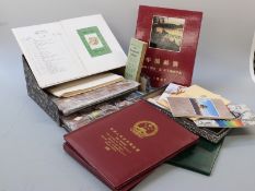 A box file of loose stamps sorted into countries, 1988 and 1997 Chinese commemorative albums, a