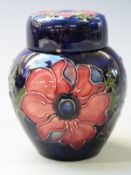 Moorcroft lidded ginger jar in Anemone pattern on a blue ground, 11cm tall