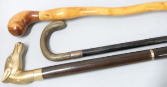 Three various walking sticks including a horn handled example with silver mount, sectional stick