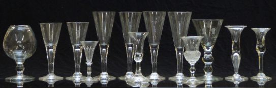 Thirteen Dartington and similar clear drinking glasses including one commemorative example in