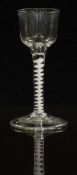 An 18thC clear drinking glass with opaque twist stem and ogee shaped bowl raised on conical foot,