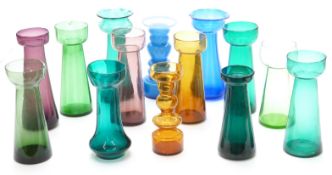 Fourteen coloured glass hyacinth vases all of elongated form, largest 20.5cm tall.