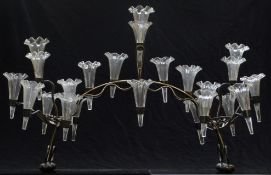 A silver plated epergne with 21 clear glass flutes, each with frilled ends, 63cm long