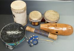 A collection of percussion instruments to include a steel pan drum, bongos, bells etc