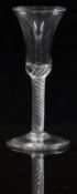 19thC clear drinking glass with air twist stem and waisted bowl, raised on conical foot, 16cm tall.