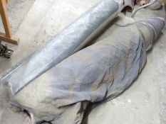 Two bolts of black velour fabric with hemmed edges, haberdashery / textile / upholstery interest,