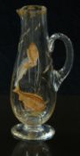 Attributed to Moser clear glass jug with enamelled decoration of fish and gilt decoration of plants,