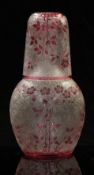 Baccarat carved cameo glass decanter and cup with cranberry decoration of flowers over an etched