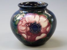 Moorcroft vase in Anemone pattern on a navy blue ground, 7cm tall