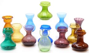 Thirteen coloured glass hyacinth vases all of squat form, largest 20.5cm tall.