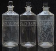 A set of three chemists/ pharmacy glass apothecary bottles with engraved labels including Lin