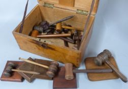 Approximately fourteen auctioneers' gavels and four blocks, in a wooden box
