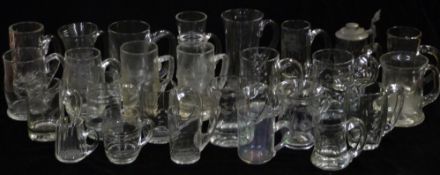 Twenty six various 19thC land later clear glass tankards, some with engraved descoration, largest