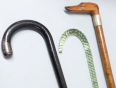 A glass cane and two others